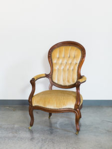 yellow vintage chair with arms