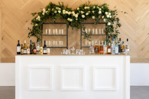 white bar in front of wood wall